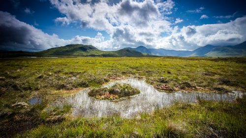 Scenic view of waterfall against sky