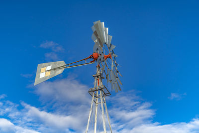 Low angle view of communications tower against blue sky