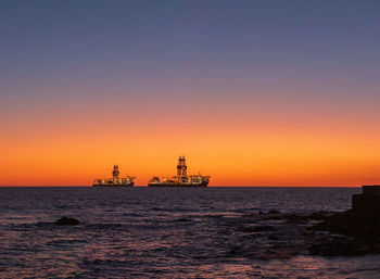 Scenic view of sea against orange sky