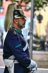 Side view of man wearing sunglasses standing outdoors