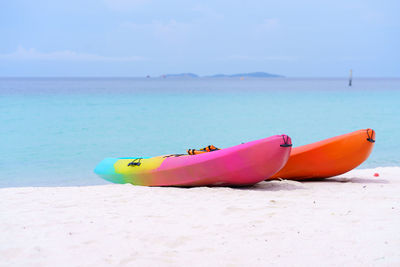 Rear view of woman sitting on beach