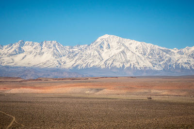 Scenic view of snowcapped mountains against blue sky