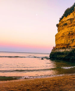 Scenic view of sea against clear sky at sunset