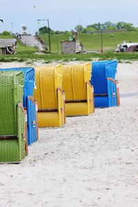 Hooded chairs on sand at beach