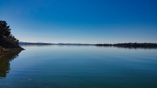 Scenic view of lake against blue sky