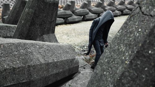 Person walking by tetrapods on field