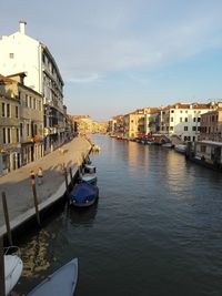 Boats in canal with buildings in background