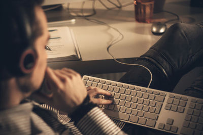 Man listening music while using computer in office