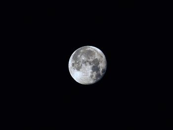 Low angle view of moon against clear sky at night