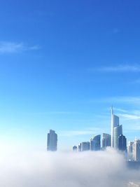 View of skyscrapers against blue sky