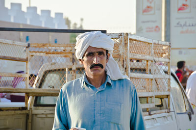 Portrait of young man standing in factory