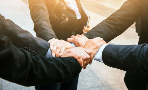 High angle view of business people forming hand chain