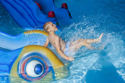 High angle view of shirtless man in swimming pool