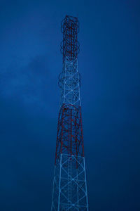 Low angle view of communications tower against blue sky