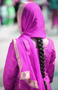 Close-up of woman with pink petals