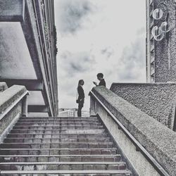 Low angle view of people walking up stairs