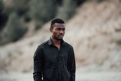 Portrait of young man standing outdoors