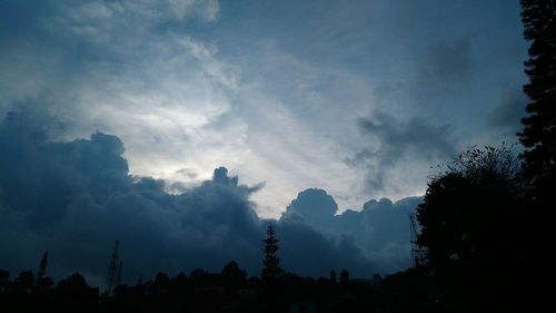 Low angle view of silhouette trees against sky