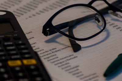 High angle view of eyeglasses on paper