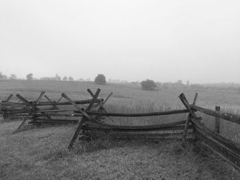 Fence on field against sky