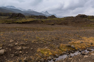 Scenic view of mountains against cloudy sky