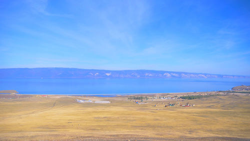 Scenic view of desert against blue sky