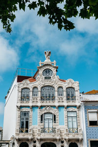 Low angle view of building against cloudy sky