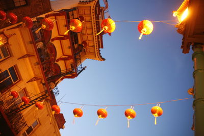 Low angle view of illuminated lanterns against sky