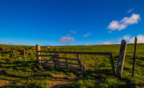 Fence on field against sky