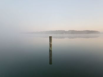 Scenic view of lake in foggy weather