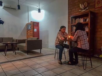 People sitting on chair at table