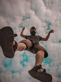 Low angle view of man skateboarding against sky