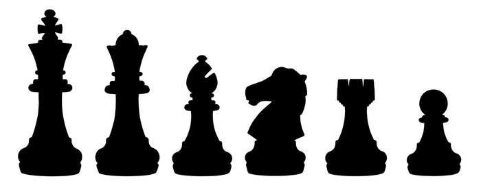 Low angle view of chess pieces against white background