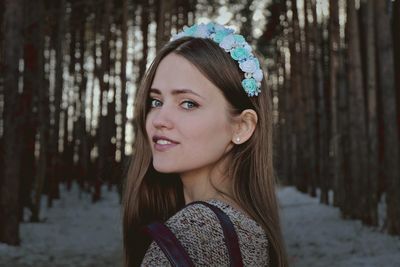 Side view portrait of beautiful young woman in forest