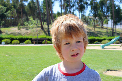 The blond boy looks into the distance with interest. thoughtful six-year-old boy.