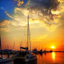 Sailboat in sea at sunset