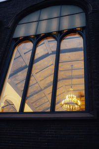 Low angle view of building seen through window