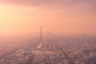 Aerial view of city district with residential buildings and eiffel tower on champ de mars in haze in paris