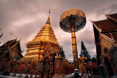 Low angle view of temple against cloudy sky during sunset