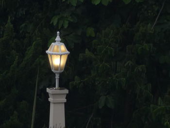 Illuminated lantern at night