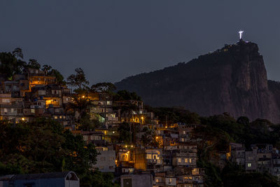 Illuminated buildings against sky at night