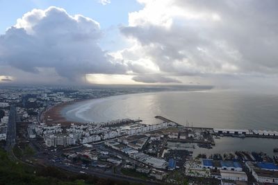 High angle view of buildings by sea against sky