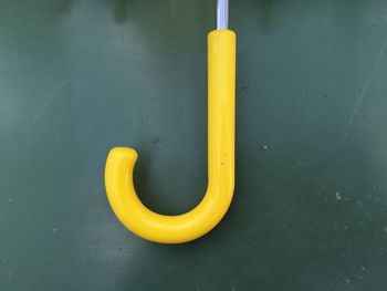 Cropped image of yellow umbrella on table