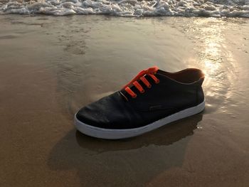 High angle view of shoes on sand at beach