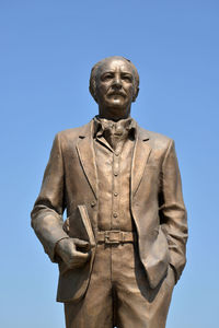 Low angle view of statue against clear blue sky