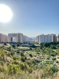 Buildings in city against clear sky
