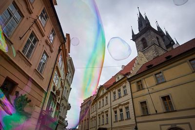 Low angle view of rainbow over buildings in city