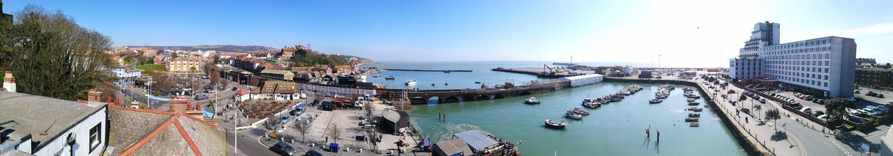 Panoramic view of city by sea against clear sky