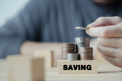 Midsection of man holding coins