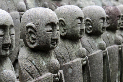 Close-up of buddha statue in cemetery